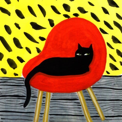 Kitty in a red chair.