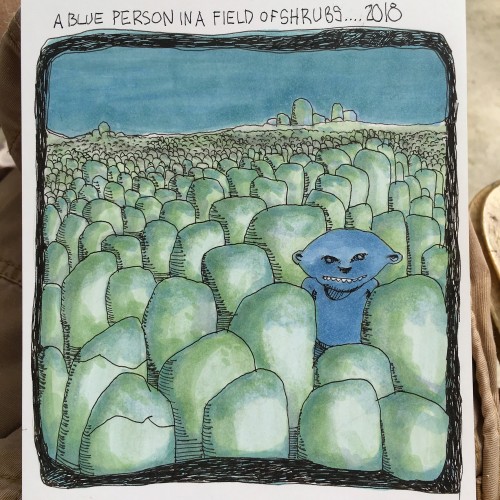 A Blue Person In A Field Of Shrubs